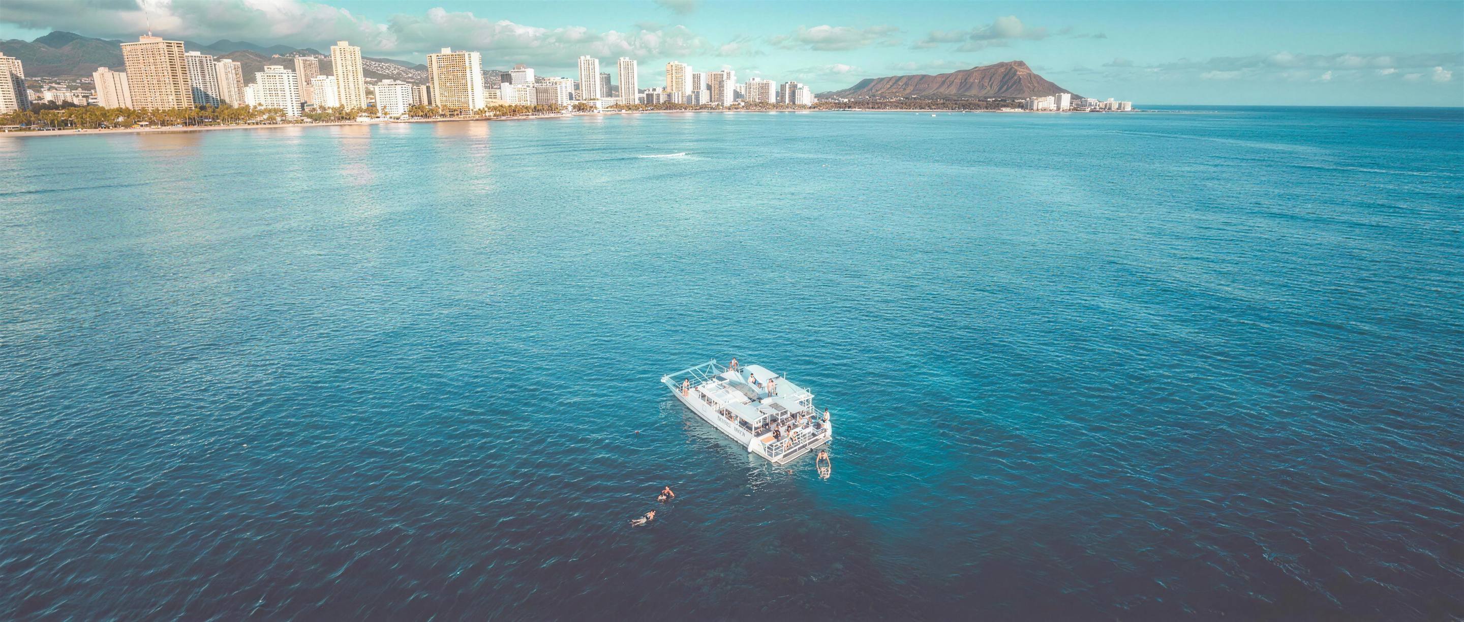 The Oceanstar boat off Waikiki, with the Waikiki skyline to the left and Diamond Head to the right