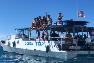 a group of people on a private boat charter with ocean star hi in honolulu, hawaii